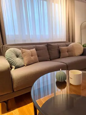 a living room with a couch and a glass table at Apartman MYKA sa privatnim parkingom in Banja Luka
