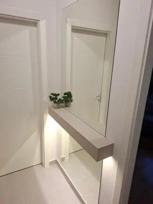 a bathroom with a mirror and two plants on a shelf at Apartman MYKA sa privatnim parkingom in Banja Luka