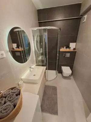 a bathroom with a sink and a shower and a toilet at Apartman MYKA sa privatnim parkingom in Banja Luka