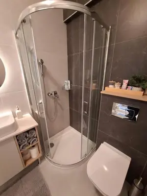 a bathroom with a shower with a toilet and a sink at Apartman MYKA sa privatnim parkingom in Banja Luka
