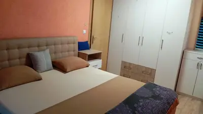 a bedroom with a large bed with pillows on it at Panonska jezera ZELENA OAZA in Tuzla