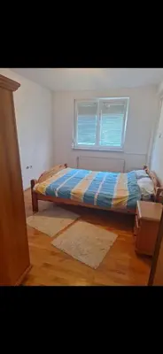 a bedroom with a bed and a window at Stan Banja Luka Nova Godina in Krndija