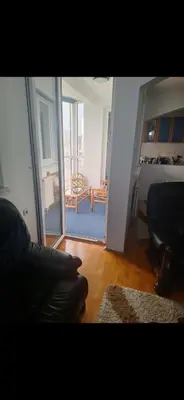 a living room with a couch and a view of a room at Stan Banja Luka Nova Godina in Krndija
