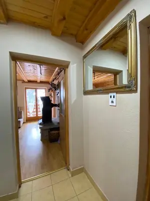 a hallway with a mirror and a stove in a room at Apartments Vlašić Eco in Šišava