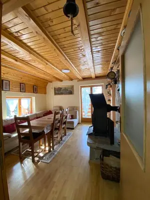 a living room with a table and a dining room at Apartments Vlašić Eco in Šišava