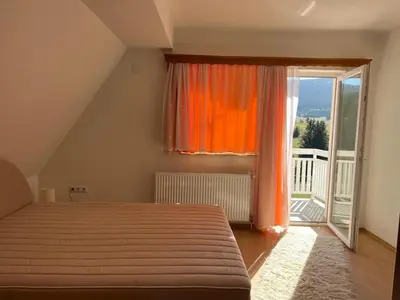 a bedroom with a bed and a large window at Planinska Draga Vlašić in Vlasic