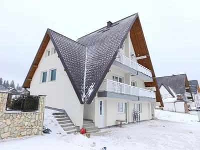 a house with a metal roof in the snow at Planinska Draga Vlašić in Vlasic