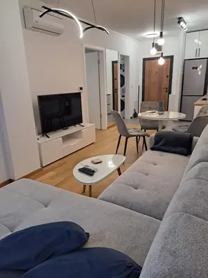 a living room with a couch and a tv at Apartment Kesten Banja Luka in Banja Luka