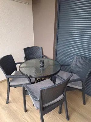 a glass table and chairs with a cup on top at Apartment Kesten Banja Luka in Banja Luka