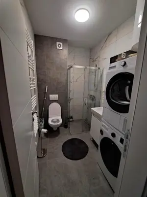 a bathroom with a washing machine and a washer at Apartment Kesten Banja Luka in Banja Luka