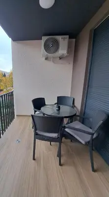 a balcony with a table and chairs and a fan at Apartment Kesten Banja Luka in Banja Luka