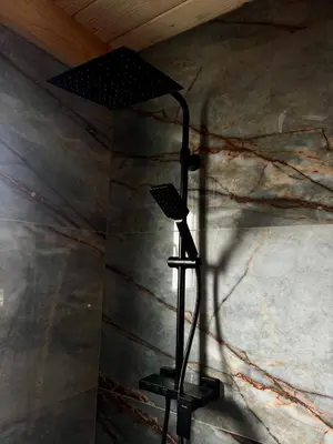 a black lamp in a room with a wall at Test Property in Bosanska Gradiška