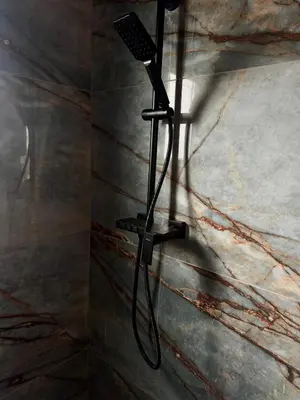 a shower in a bathroom with a black shower head at Test Property in Bosanska Gradiška