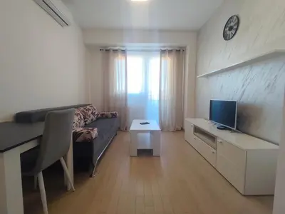 a small living room with a couch and a television at Gray Heaven Retreat in Banja Luka