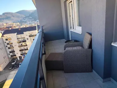 a balcony with two chairs and a view of a city at Gray Heaven Retreat in Banja Luka