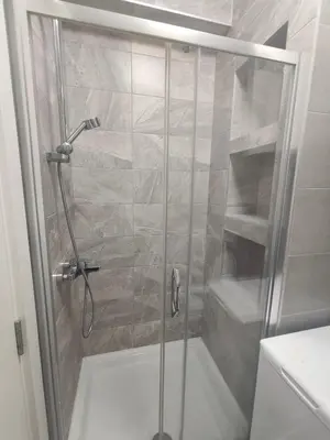 a shower with a glass door in a bathroom at Gray Heaven Retreat in Banja Luka