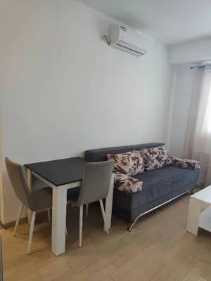 a living room with a couch and a table and chairs at Gray Heaven Retreat in Banja Luka
