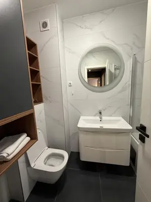 a bathroom with a sink and a toilet and a mirror at Apartman sa dvije sobe in Banja Luka