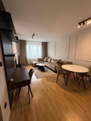 a large living room with a couch and tables at Apartman sa dvije sobe in Banja Luka