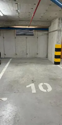 a parking garage with a handicapped sign on the floor at Apartman sa dvije sobe in Banja Luka