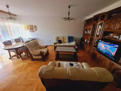 a living room with a couch and a dining room at KT Apartment City Centar in Banja Luka