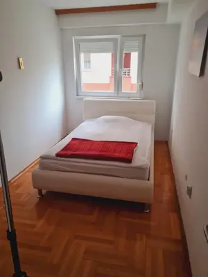 a bed in a room with a window at KT Apartment City Centar in Banja Luka