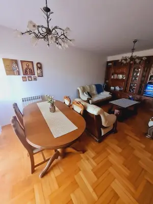 a living room with a wooden table and chairs at KT Apartment City Centar in Banja Luka