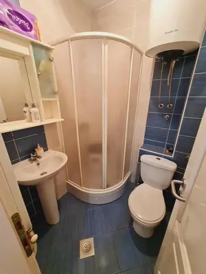 a bathroom with a shower and a toilet and a sink at KT Apartment City Centar in Banja Luka