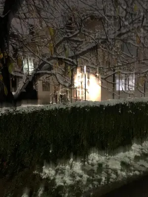 a house with lights on in the snow at Vista Dubica in Bosanska Dubica
