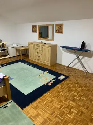 a living room with a table and a blue rug at Vista Dubica in Bosanska Dubica