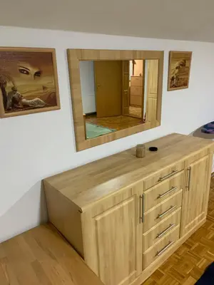 a bathroom with a wooden vanity with a mirror at Vista Dubica in Bosanska Dubica