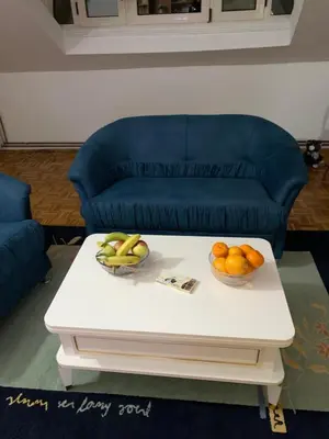 two bowls of fruit on a coffee table in front of a couch at Vista Dubica in Bosanska Dubica