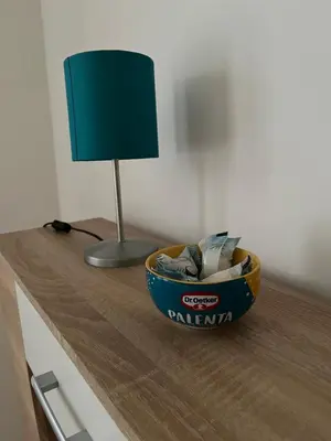 a bowl on a counter with a lamp on it at Apartman Mila Prnjavor in Prnjavor