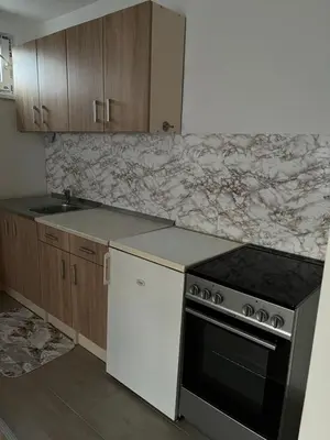 a kitchen with a stove and a counter top at Apartman Mila Prnjavor in Prnjavor
