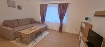 a living room with a couch and a table at Apartman Mila Prnjavor in Prnjavor