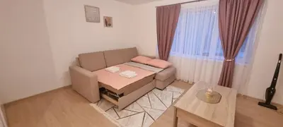 a living room with a couch and a table at Apartman Mila Prnjavor in Prnjavor