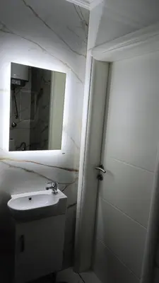 a bathroom with a sink and a mirror at Stan na dan in Visoko