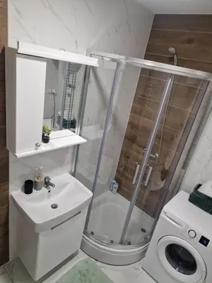 a bathroom with a shower and a toilet and a sink at Apartman Green Oaza in Doboj