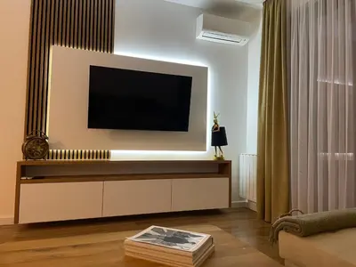 a living room with a flat screen tv on a wall at Apartman KK VII in Banja Luka