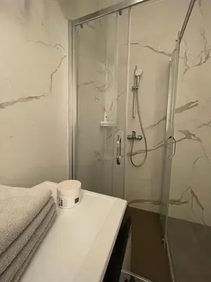 a bathroom with a shower with a glass door at Apartman KK VII in Banja Luka