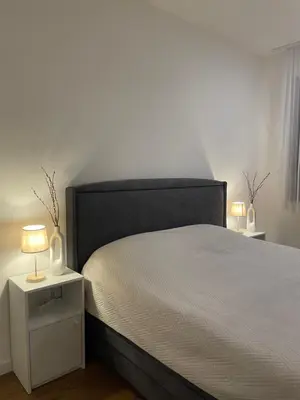 a bedroom with a bed and two lamps on a night stand at Apartman KK VII in Banja Luka