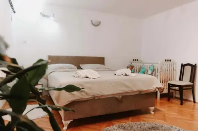 a bedroom with a bed with towels on it at Apartman CENTRAL LOFT Gradiška in Bosanska Gradiška
