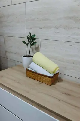a wooden table with a pillow and a plant on it at Apartman CENTRAL LOFT Gradiška in Bosanska Gradiška