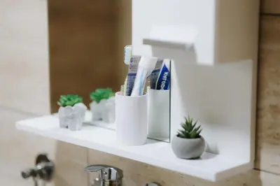 a bathroom shelf with toothbrushes and toothpaste at Apartman CENTRAL LOFT Gradiška in Bosanska Gradiška