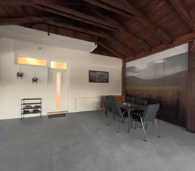 a room with a table and chairs and a window at Apartman Anita in Kupres