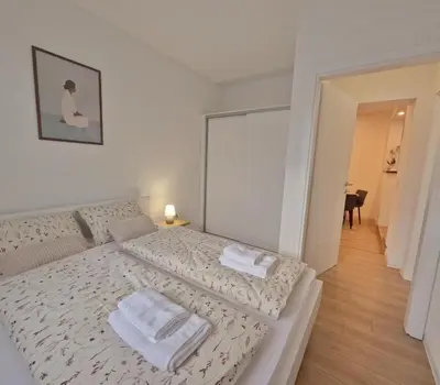 a bedroom with a bed with towels on it at Apartman Anita in Kupres