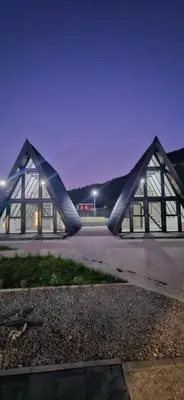 a building with two triangular roofs at night at Golden Spa A-Frame 1 in Bihać