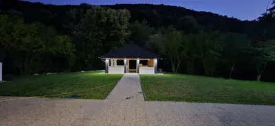 a small building in a grassy field with a pathway at Golden Spa A-Frame 1 in Bihać