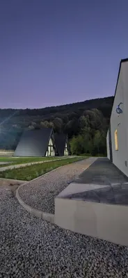 a house and a road next to a building at Golden Spa A-Frame 1 in Bihać