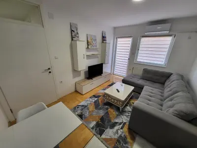 a living room with a couch and a tv at Apartman Magi in Prnjavor